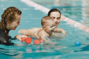Mother and little son in a swimming pool